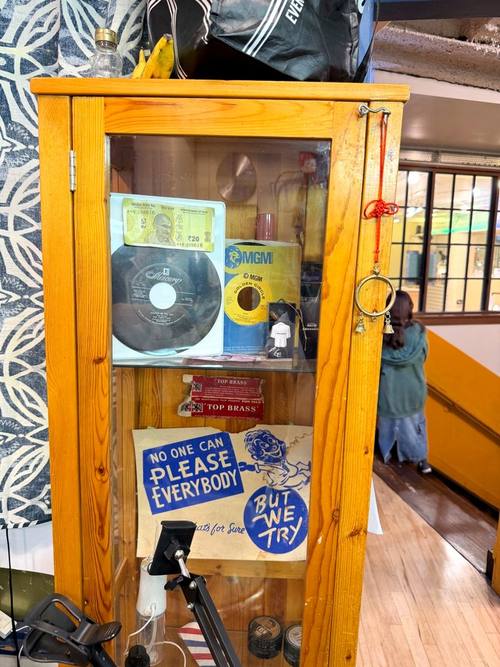 Display cabinet with vintage barbering memorabilia at Balcony Barber Shop