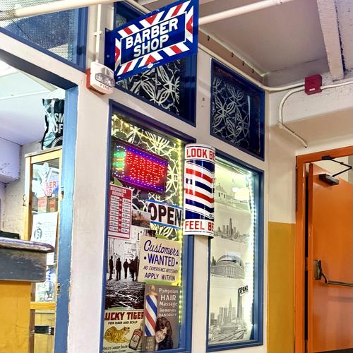 Balcony Barber Shop entrance with barber pole at Pike Place Market